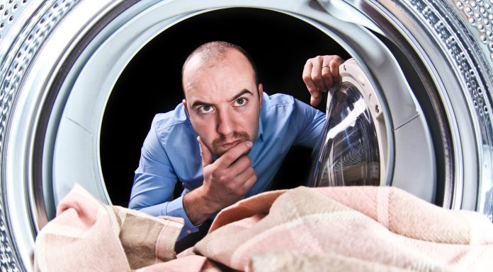 man thinking about washing symbols and their compatibility with the machine